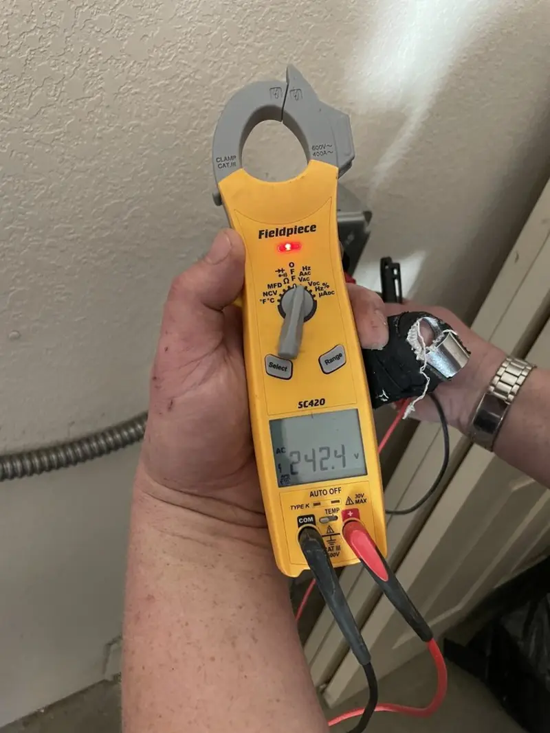 Voltage testing with clamp meter during Recessed Lighting Installation in Winchester